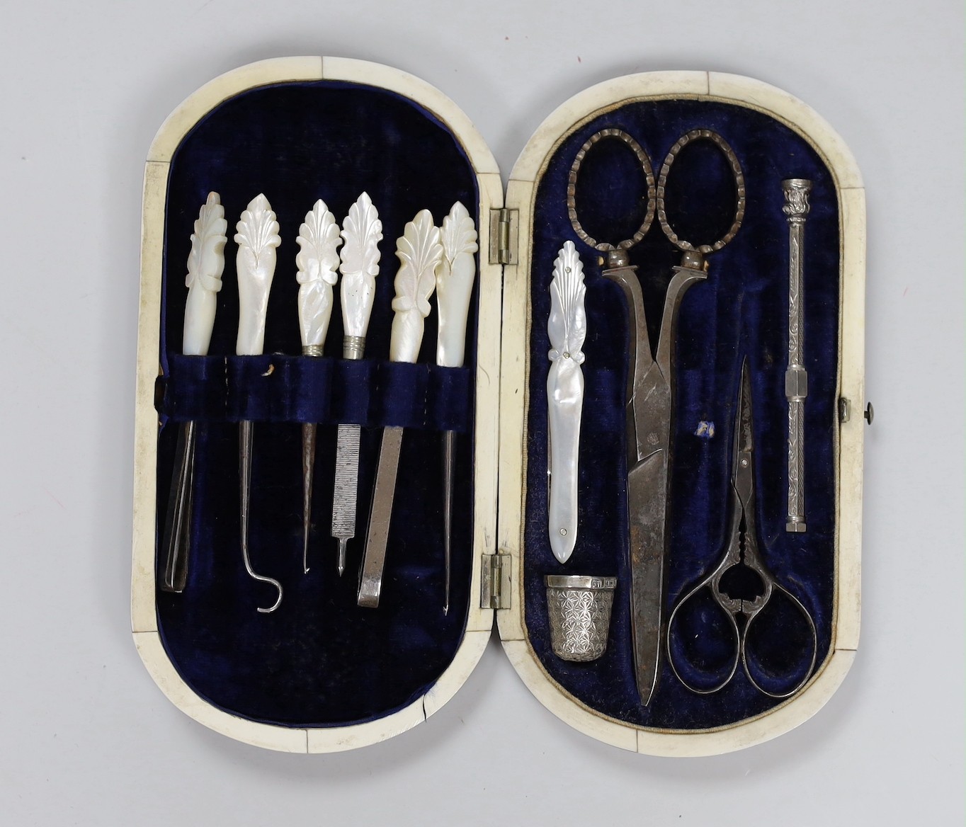 A Victorian tortoiseshell cased necessaire set, containing mother-of-pearl and steel tools, silver thimble and propelling pencil with ivory edging